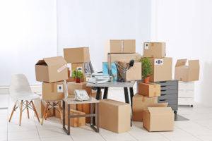 Move concept. Unpacking cardboard boxes in a new office
